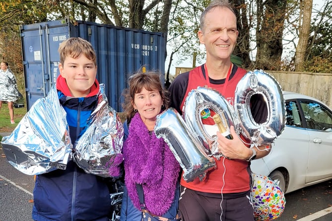 Colin Bunting with his family after completing his 100th marathon