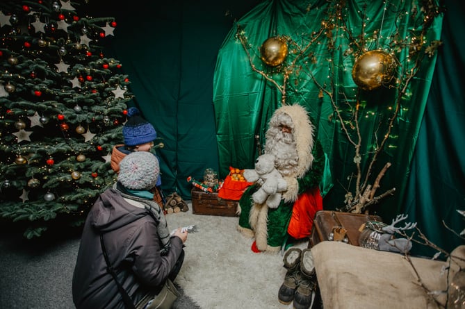 A child meets Father Christmas at Redruth's Festive Saturday
