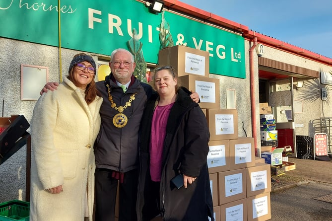 Mayor of Penzance Jonathan How with Mia and Julia from Food for Families CIC after he had donated 50 Christmas food hampers      