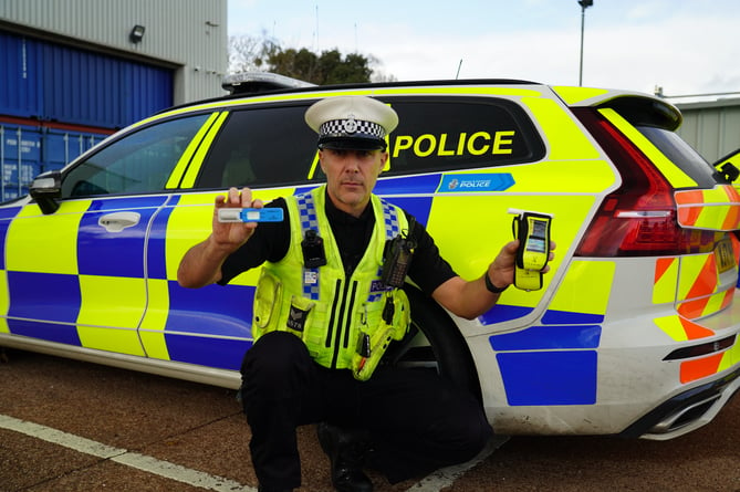 Sergeant Owen Messenger with a drug wipe and breathalyser device. 