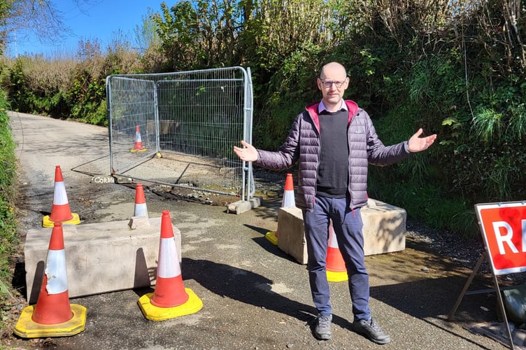 A frustrated Cllr Colin Martin at the scene of the Lostwithiel pothole, which has closed the road