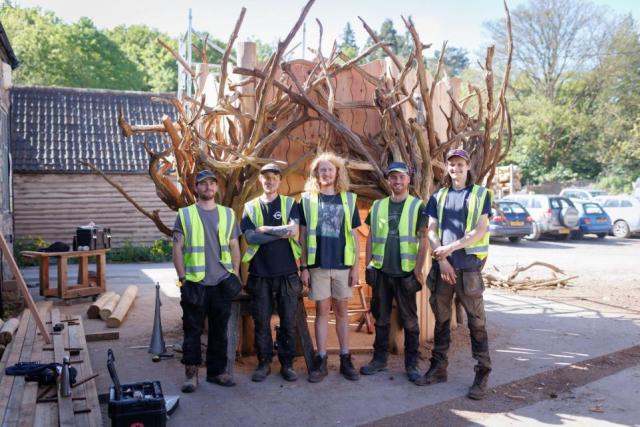 The TouchWood Play team are pictured with the giant Tree of Life Tower before it was lowered into position at the Eden Project
