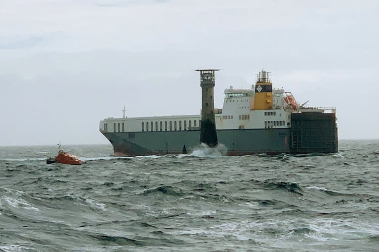 This is the dramatic moment a huge cargo ship came close to hitting a 135-foot tall lighthouse - eight miles off the British coast this morning (mon).  See SWNS story SWSMship.  The 640-foot-long Roll-on-Off (RO) vessel Mazarine hit rocks close to the Wolf Rock lighthouse off Land's End, Cornwall, according to some unconfirmed reports.  The vessel, bound to Belgium from southern Ireland, had suffered engine failure.  The RNLI sent two all weather lifeboats to stand-by as a salvage tug and a Coastguard helicopter headed towards the stricken vessel.   