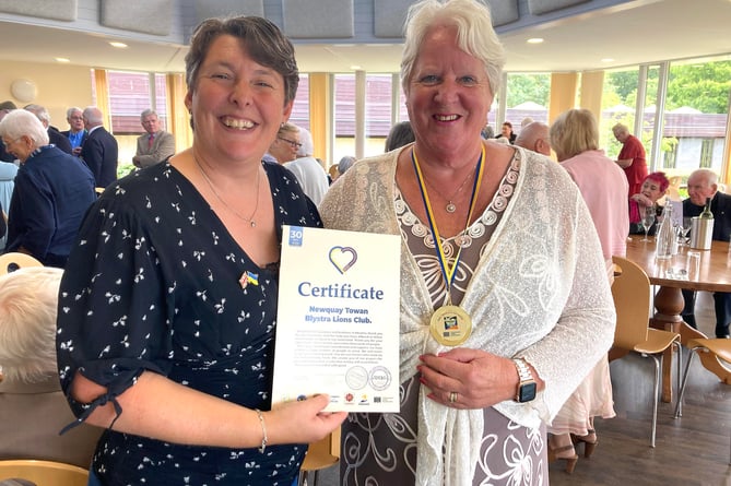 Lion Jill Bunt receives the certificate from Lion Emma Bernard of Callington on behalf of Cornwall and Devon Sending Love to Ukraine