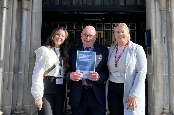 Chloe French and Leah Vincent outside the Houses of Parliament with demenita academic lead Ian Sherriff