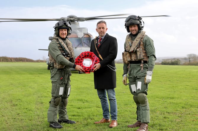 RNAS Culdrose personnel Lieutenant Commander Steve Ivill, left, and Petty Officer Aircrewman James Armstrong, with The Veterans Charity trustee Iain Henderson, centre