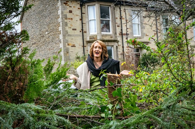 Sarah Yardley photographed in her Garden, Wadebridge, Cornwall, December 19, 2023 after someone reached over her garden wall and stole the top of a christmas tree.  Release date â December 20, 2023.  See SWNS story SWLNtree.  A woman was left "confused" after a Christmas tree was chopped down and stolen in the middle of the night - from her back garden.  Sarah Yardley, 40, received a strange text from friends leaving her Christmas party on Friday night (Dec 15) - informing her they had spotted someone hopping over her fence with half a tree.  Sarah, who has been living in the Wadebridge for seven years, said: "What a funny set of experiences!"  The fir tree was located in Sarah's back garden, adjacent to her house, which is enclosed by a stone wall roughly five foot tall, with a gate in the center.  Sarah had around 30 people over for a Christmas celebration on Friday - but there was someone who turned up uninvited. 