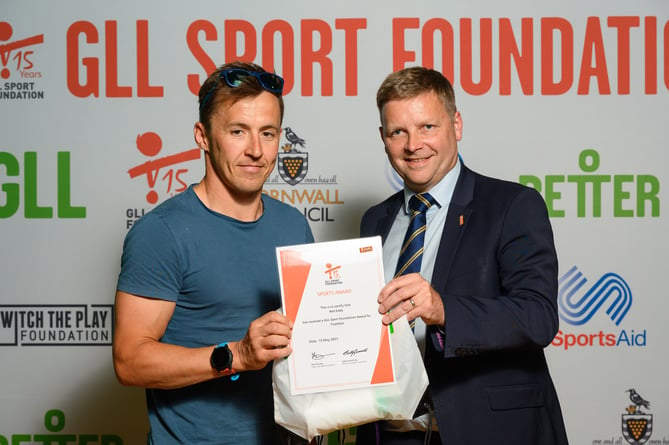 Triathlete Neil Eddy receives his GSF award from James Curry, GLL’s Head of Service in Cornwall