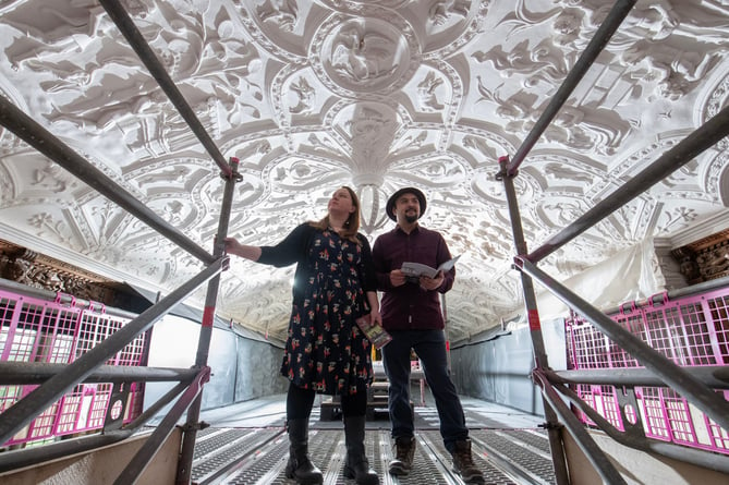 Two visitors on scaffolding to view the Long Gallery ceiling at National Trust Lanhydrock, as part of the project to conserve the ceiling