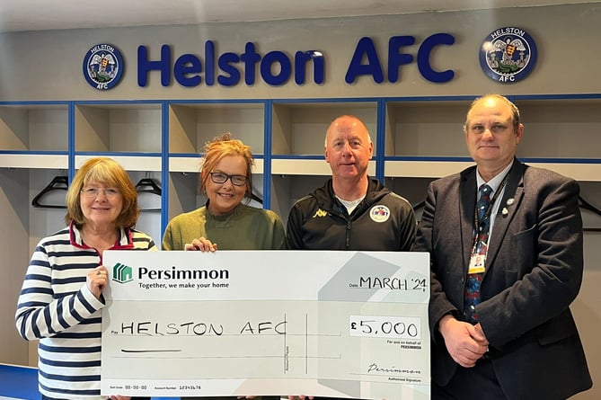 Helston Athletic receiving the cheque. From left: Sandra Egan (club treasurer), Jane Cartwright, Paul Hendy and Cllr Guy Foreman.