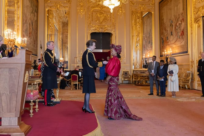 Charity Gladstone receiving her MBE from the Princess Royal