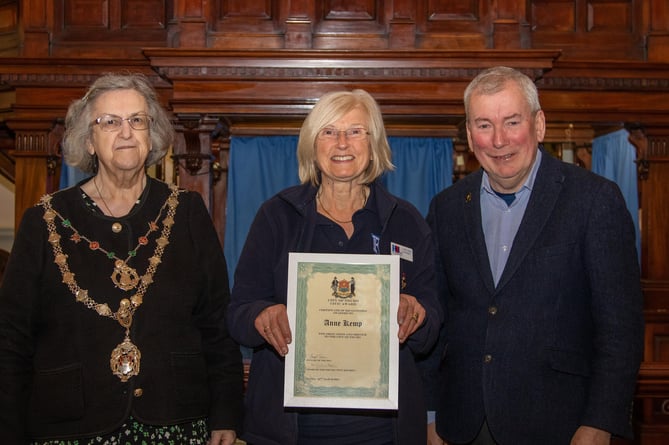 Anne Kemp of Truro Royal British Legion receives her award from Cllr Carol Swain and Malcolm Bell 