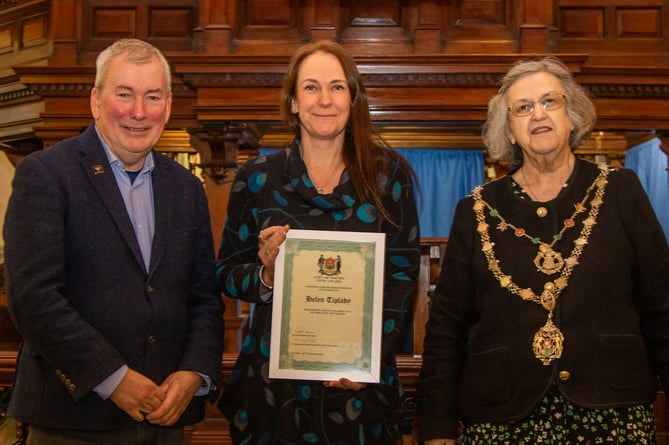 Helen Tiplady receives her award from Malcom Bell and Cllr Carol Swain 