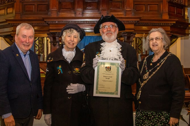 Town crier Lionel Knight and wife Carol receive their award from Malcom Bell and Cllr Carol Swain 