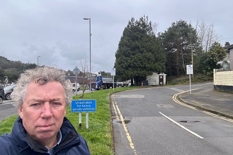 Cllr Rob Nolan and the patch of land, near Truro's Tesco roundabout, which could be sold off by Cornwall Council