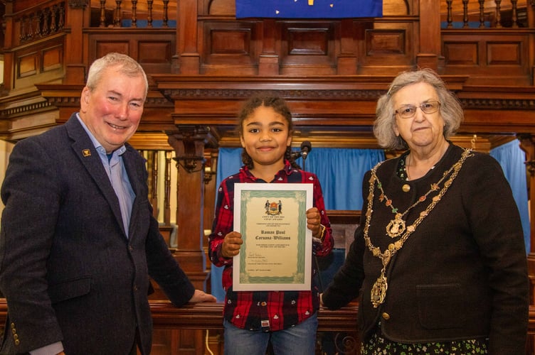 Roman Caruana-Williams receives his award from Maclcom Bell and city mayor Cllr Carol Swain