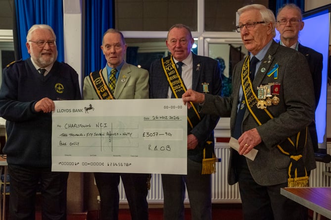 Members of the Buffaloes present the giant cheque to Richard Parks.