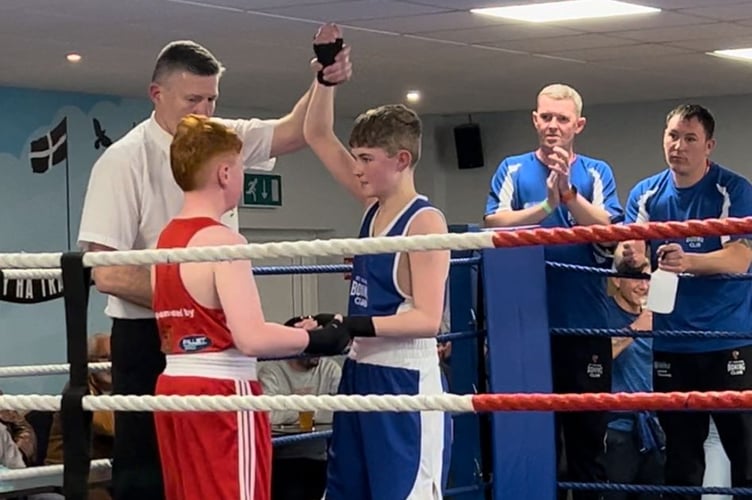 Riley (blue) celebrates his success while consoling his opponent.