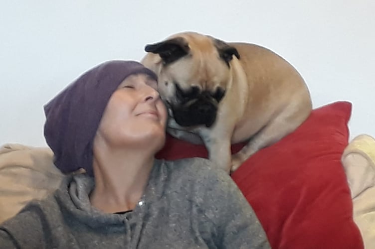 Rebecca Bridges with pet dog, pictured during her cancer treatment. Release date April 30 2024. A man donated his stem cells to save his sister's life after she was diagnosed with a rare form of cancer. Rebecca Bridges, 54, was diagnosed with acute myeloid leukaemia - an aggressive cancer of the myeloid cells - in August 2020 after suffering from breathlessness, aching joints and bleeding gums. She underwent two rounds of chemotherapy and was told she would need a stem cell transplant - to treat conditions in which the bone marrow is damaged and is no longer able to produce healthy blood cells.