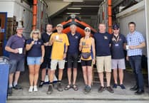 Couple walking British coastline in aid of the RNLI visit Newquay lifeboat station