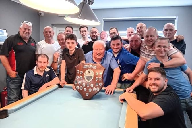 Members from both teams in front of the Roger Stephens Shield.