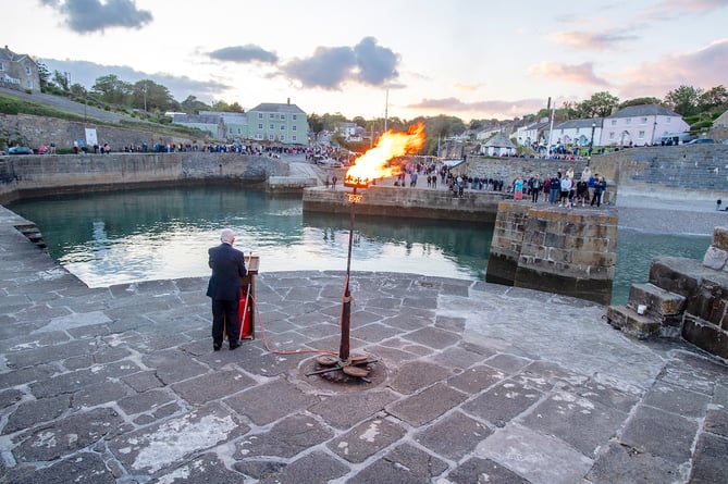 People gathered around the harbour at Charlestown for the lighting of a D-Day beacon. Picture: Paul Williams