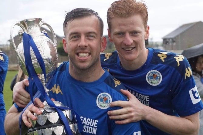 Tom Payne (left) and Rikki Shepherd, pictured celebrating Helston's Western League Premier title victory back in April, are joining Saltash United for the new season.