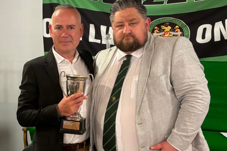 Dave Taylor (left) with the Clubperson of the Year award which was represented by football chairman Darren Kirwan.