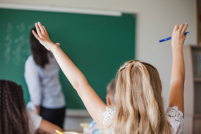Raised hand in a classroom