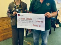 Brownie Pippa gives cheque to Sunny Corner