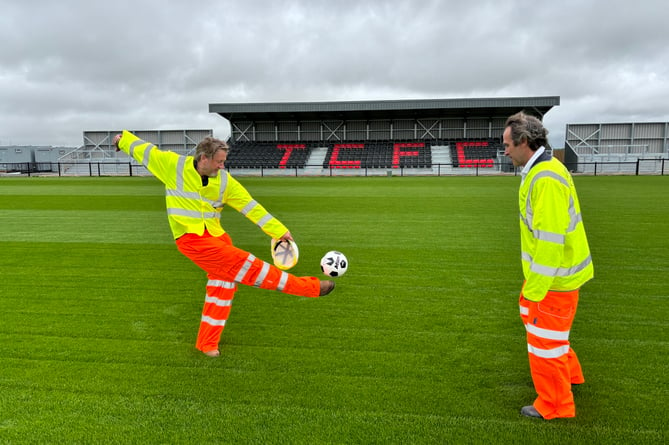 Treveth's Harry Lewis, left, and Cornwall councillor Olly Monk have a kickabout on the new pitch