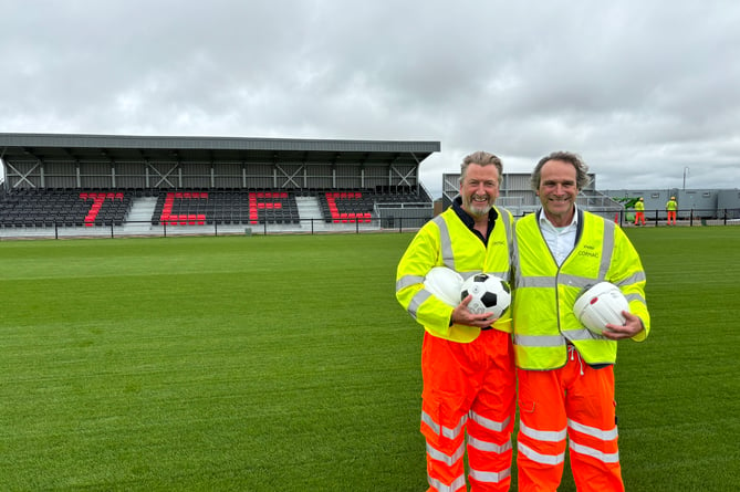 Treveth's Harry Lewis, left, and Cornwall councillor Olly Monk on the new pitch at Truro City's ground at Truro Sports Hub