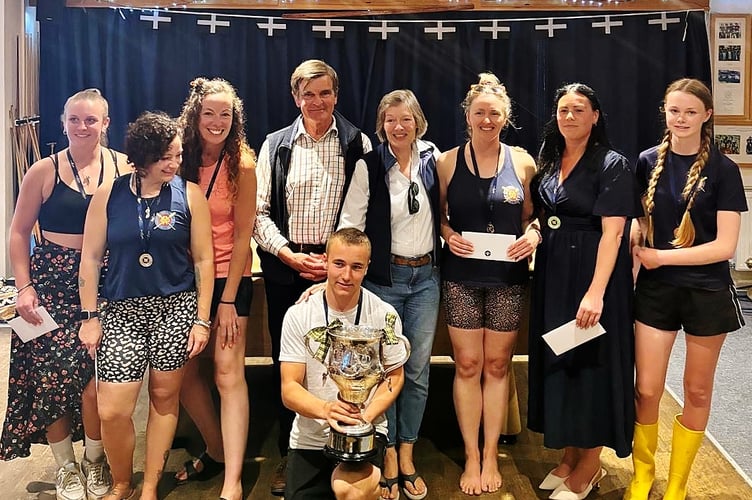 Carolyn and John Armstrong, pictured in the centre of the back row, present The Headland Cup to the winning crew.