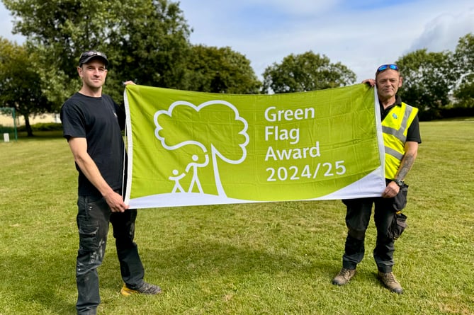 Camborne Town Council Amenities Team staff proudly display the prestigious Green Flag Award