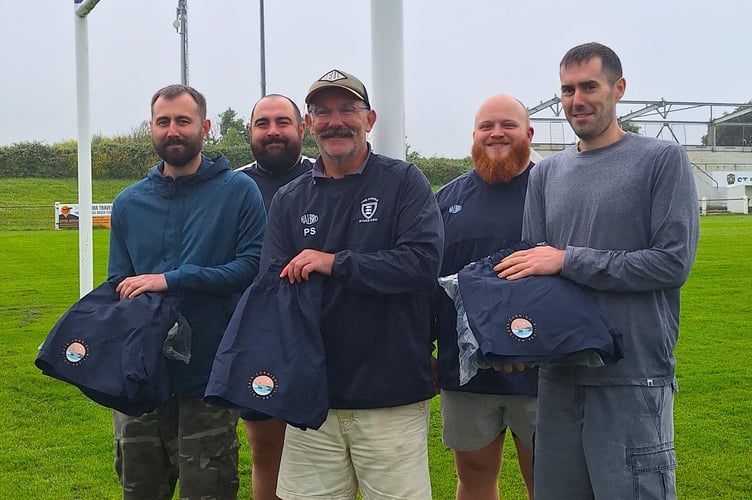 Matt Nellyer (director of Cornish Riviera Holidays), Liam Trudgeon (first team prop); Paul Sanders (St Ives first team manager), Hayden King (player and forwards coach for St Ives); and Andy Dale, director of Cornish Riviera Holidays each holding the team shorts at Alexandra Road.