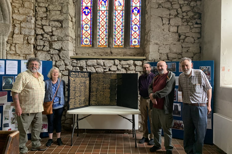 The Loyal Basset Lodge of Oddfellows Honour Board beneath the Oddfellows stained glass window in Camborne Church with Oddfellows members and Camborne Church Wardens, David Thomas and David Fielding 