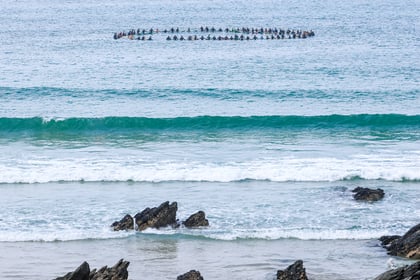 Memorial paddle out held for surfing pioneer