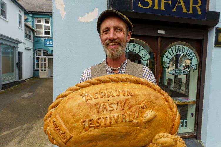 Artist Cosmic enjoying a giant pasty at Mining & Pasty Festival