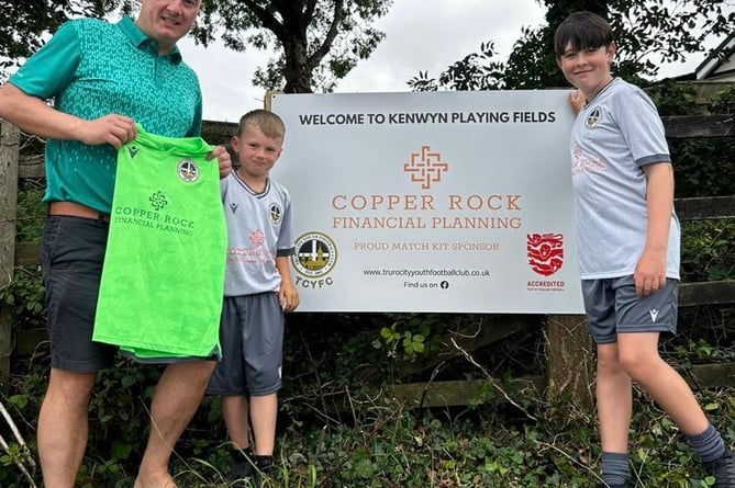 Scott Whitfield from Copper Rock Financial Planning presents new football kits to Truro City YFC players