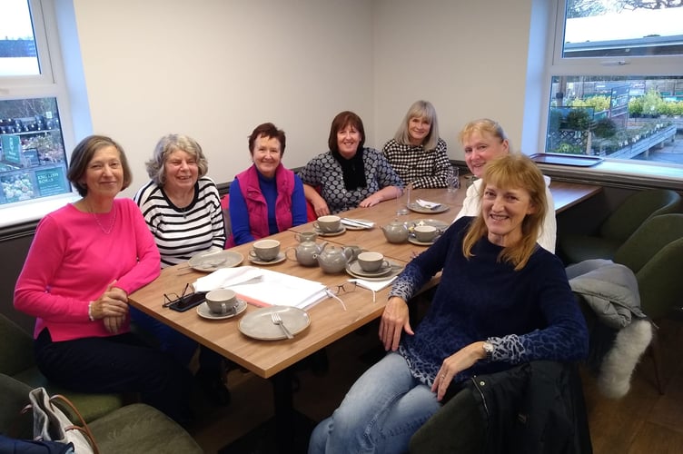 The photo shows some of the bakers and delivery team celebrating their 5,000th slice milestone with a piece of cake at a local café. Pictured are Dinky, Cath, Jan, Morna, Alexis, Jackie, and Penny.