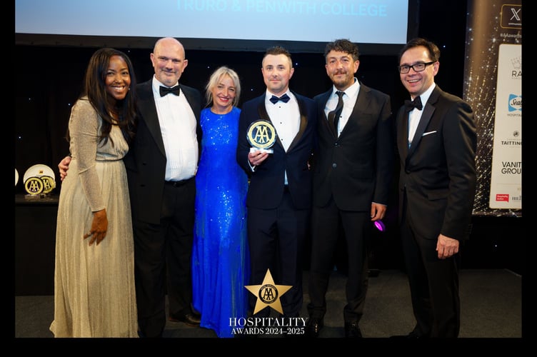 Hospitality lecturers Dean Bungay and Elly Owen collecting award from Celebrity MasterChef winner Angellica Bell