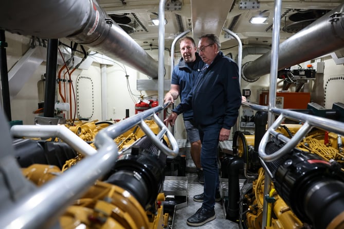 Mayor of Concarneau Marc Bigot is shown around the Penlee RNLI lifeboat by coxswain Patch Harvey. Photo by Penzance Council.