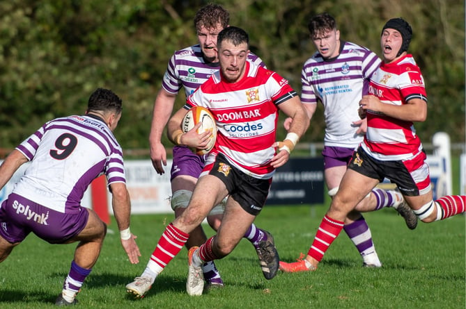 St Austell centre Ben Plummer side-steps Exmouth scrum-half Matt Ryan. Picture: Dave Phillips