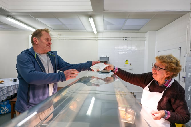 Wayne Sanders is handed a pasty from Street Food Project volunteer, Linda McKechnie. Run by Growing Links CIC, Street Food Project is welcoming some of the communityâs most vulnerable people into its brand new premises at the Safe & Well Hub, the former John Daniel Centre in Heamoor. Growing Links CIC was awarded Â£8,313 of grant funding from Penzance Council to buy and install a commercial kitchen in the building. Photo by Penzance Council.