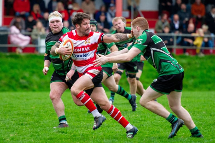 St Austell scrum-half Matt Shepherd hands off a Ivybridge defender as he breaks clear. Picture: Dave Phillips