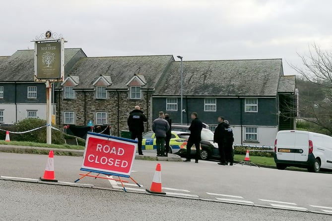 Police at the scene in Helston where the discovery of man's body in car has sparked a murder probe.  Release date  December 19, 2024.  Two women - including one in her 80s - have been arrested on suspicion of murder and concealing the body of a victim.  The suspects were detained after a murder probe was launched after the body of a man was found in a vehicle at the Helston Business Park in Cornwall.  Police were making enquiries in the Helston area in the early hours of Wednesday 18 December following concerns for welfare.  A man in his 60s, from the Somerset area, was confirmed dead at the scene. His next of kin have been informed.  Two women aged in their 50s and 80s, also from Somerset, have been arrested on suspicion of murder, concealing a death, and preventing a lawful burial. They remain in police custody at this time. 