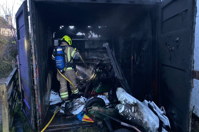 Firefighters deal with the fire in a container belonging to Saltash Cricket Club at Chapel Field