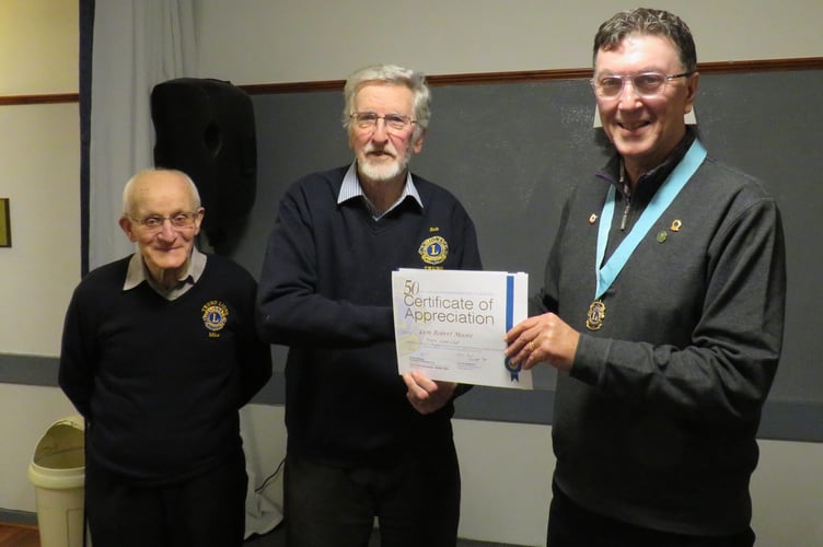         Vice District Governor Richard Allen presents Bob Moore with a certificate of appreciation in the presence of Truro Lions president Mike Kalis                       