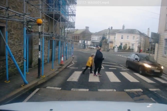 The mother and son can be seen hesitating to cross as the vehicle ignores their presence on the zebra crossing and drives over it ahead of them. (Picture: Lisa Burrows)