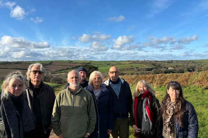 Some of the members of the Stop Trelion Solar Farm group. The panels would run across the ridge of the hill behind them.